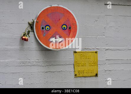 No-parking traffic sign painted as smileys at a parking garage in Düsseldorf, Germany Stock Photo