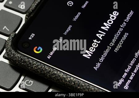 The AI Mode is turned on in the Google app on the screen of a smartphone. Stock Photo