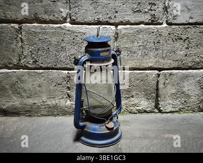 An old lantern with a brick wall background Stock Photo