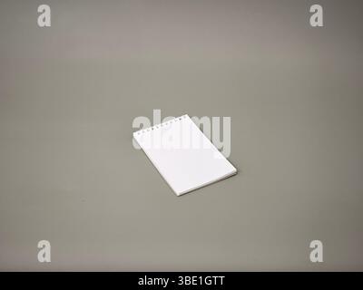 A small notebook over a grey background Stock Photo