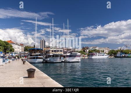Small Cruise boats moored in Split harbour / marina beside the waterfront promenade, Split, Croatia, Europe Stock Photo