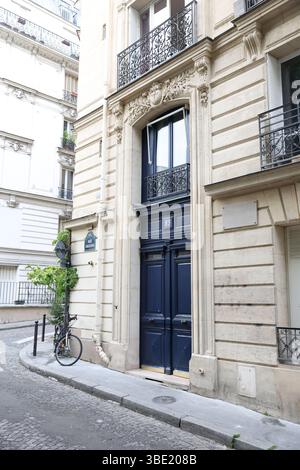 Elegant Dark Blue Parisian Doorway (Number 13) with Ornate Carving and Bicycle on Cobblestone Corner Stock Photo