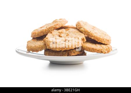 Sweet oatmeal cookies on plate isolated on a white background. Stock Photo