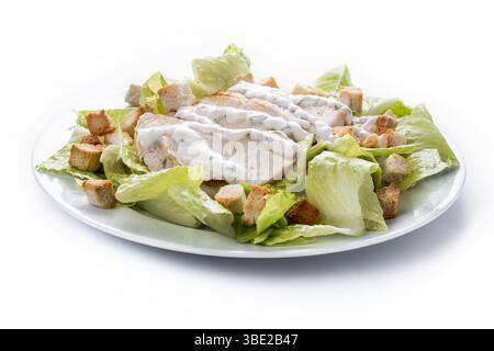 A fresh and crunchy Caesar salad made with crisp romaine lettuce, creamy Caesar dressing, crunchy croutons isolated on white background Stock Photo