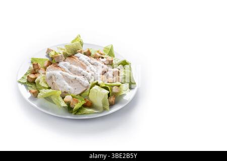 A fresh and crunchy Caesar salad made with crisp romaine lettuce, creamy Caesar dressing, crunchy croutons isolated on white background Stock Photo