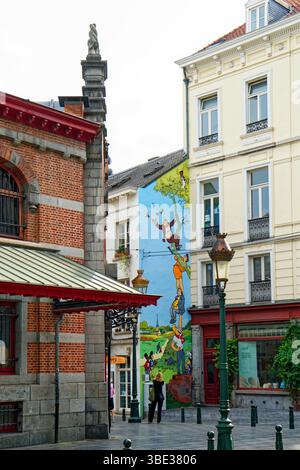 Belgium, Brussels, historic center, Place Saint Gery, Halles Saint Gery, former covered market founded in 1881 and wall painted in comics with characters from Néron et Cie by Marc Sleen in the background Stock Photo