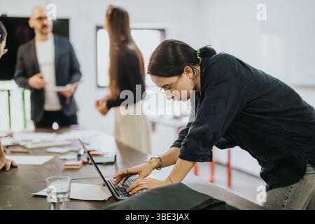 Students collaborating on a project with their supportive professor Stock Photo