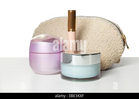 Cosmetic products and bag isolated on white Stock Photo