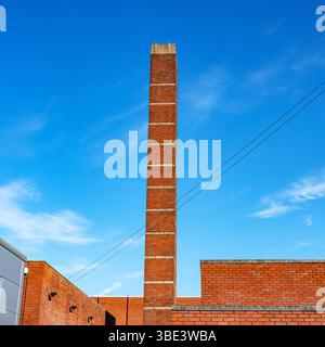 Industrial chimney isolated against blue sky Stock Photo