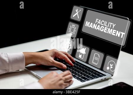 Businesswoman using a laptop and showing a facility management icon. Tablet on the table. Technology innovation on a virtual screen. Concept of facili Stock Photo