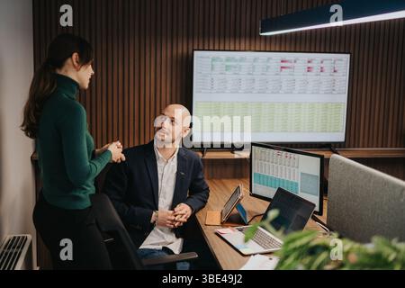 Collaborative business meeting between two coworkers in an office environment, representing mutual understanding and partnership building Stock Photo