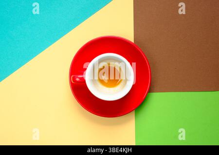 Espresso cup with saucer on two tone background with drunk delicious fresh brewed espresso coffee. Free copy space. Stock Photo