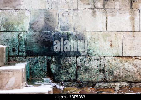 lichen covered old stone wall and steps in monastery in Andronikov Monastery of the Saviour in Moscow city in spring Stock Photo