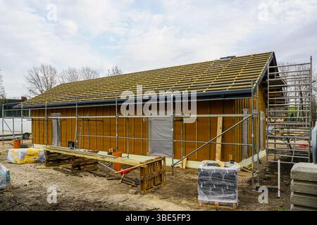 Construction phase of a modern single story eco friendly timber framed house, roof structure and wall framework Stock Photo