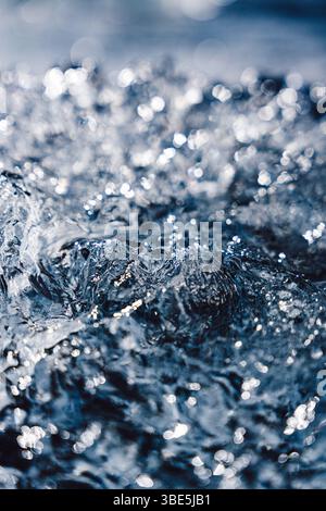 A stunning close-up of an ice surface, with light reflecting off its crystalline structure, creating a serene and abstract composition at Diamond Beac Stock Photo