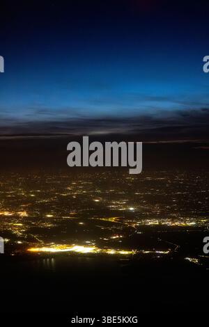 Aerial view of the urban landscape at dusk, featuring dense buildings ...