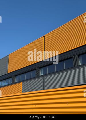 Modern industrial office building facade with stacked windows and metal ...