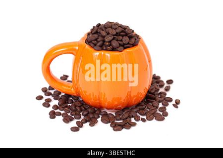 Pumpkin Mug Filled with Whole Coffee Beans on a White Background Stock Photo
