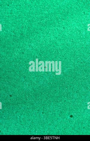Background of porous foam rubber. Green foam rubber. Packaging material. Stock Photo