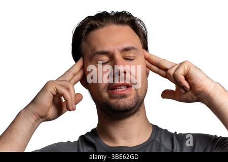 Young tired with headache man portrait isolated on white background Stock Photo