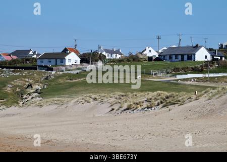dugort beach known as silver strand or pollawaddy with view of the town achill island county mayo republic of ireland Stock Photo