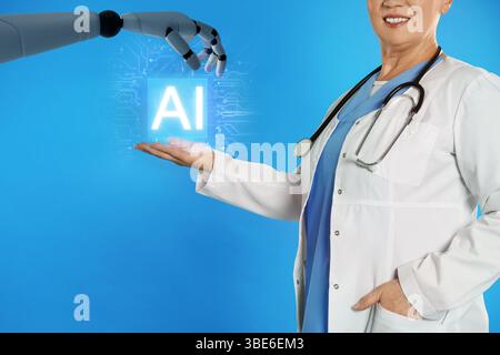 Robot hand and doctor with virtual AI microchip against blue background, closeup. Artificial intelligence in medicine Stock Photo