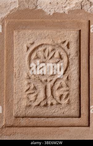 Ornate carved stone panel features intricate geometric patterns at Al-Jalahma House on the Pearling Path in Muharraq Stock Photo