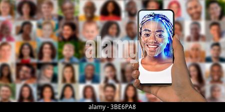A person holds a smartphone displaying a facial recognition scan of their face Stock Photo