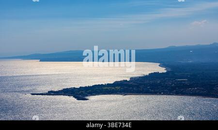 Taormina, Sicily, Italy - February 15, 2023: Panoramic view of Taormina shore at Ionian sea with Castello Saraceno castle, Giardini Naxos and Villagon Stock Photo