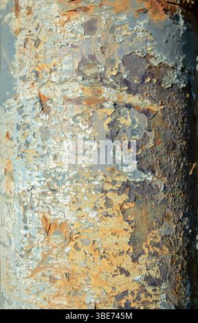 Rust on a metal pole painted blue. Natural oxidation. Stock Photo