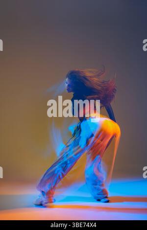 Group of dancers executing jazz-funk routines in a contemporary studio setting, highlighting expressive movements and coordinated energy. Stock Photo