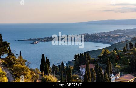 Taormina, Sicily, Italy - February 15, 2023: Panoramic view of Taormina shore at Ionian sea with Giardini Naxos and Villagonia towns and in Messina re Stock Photo