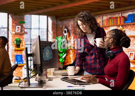 Team of admins working in AI tech agency providing custom software development services. Teamworking startup office colleagues using artificial intelligence technology to streamline coding process Stock Photo
