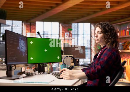 System administrator using isolated screen PC working with artificial intelligence technology in tech startup. Mockup computer display used by IT expert developing AI systems in tech startup Stock Photo