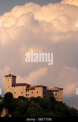Majestic Castle Against Dramatic Clouds on a Scenic Hilltop Stock Photo