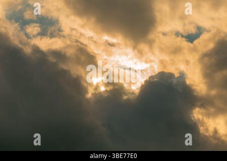 Dreamy Golden Clouds Shining with Sunlight in Illuminated Sky Stock Photo