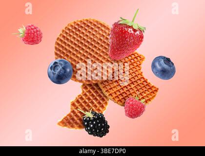 Tasty Dutch waffles and fresh berries flying on pink gradient background Stock Photo