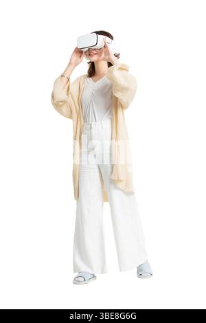 A young woman in loungewear playing VR games​ Stock Photo