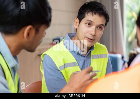Green tech dialogue among engineers during sustainable project planning Stock Photo