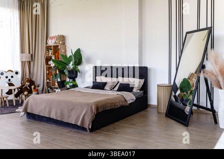 Bedroom interior with children's area and flower pots Stock Photo