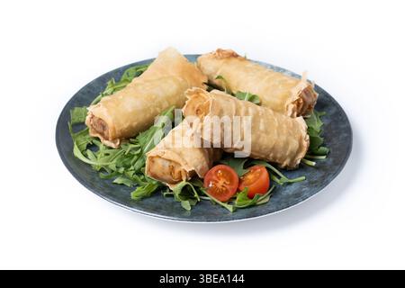 Crispy vegetables spring Rolls on Ceramic Plate isolated on white background Stock Photo