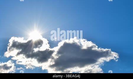 Dramatic cloudscape with sunlight streaming through clouds Stock Photo
