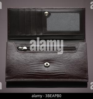 Fashionable designer leather wallet on a brown background Stock Photo