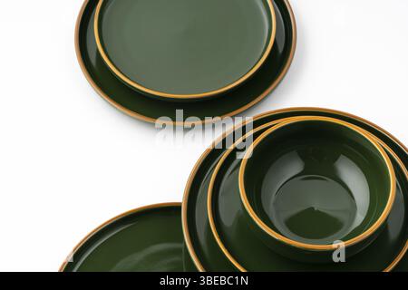 A set of green ceramic plates and bowl on a white background Stock Photo