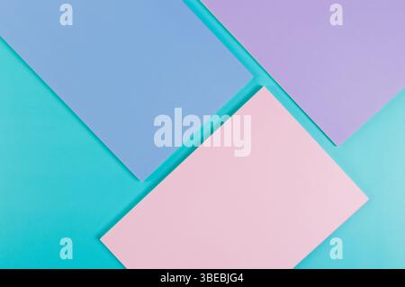 Top view of pink, purple and blue notebooks on blue background. School, office wallpaper. Flat lay, copy space. Stock Photo