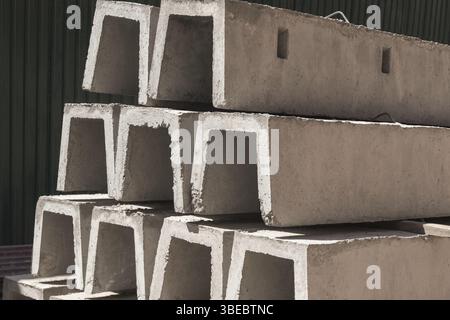 New concrete blocks for drainage, stacked in a row. building material Stock Photo