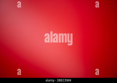 A vibrant abstract red wallpaper featuring smooth gradients, soft textures, and a modern design ideal for digital or interior use. Stock Photo