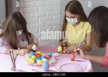 Quarantined sick family paints eggs for Easter Stock Photo