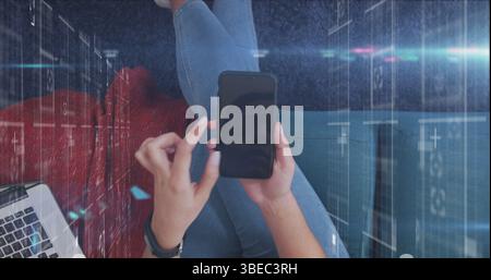 Image of spot of light and data processing against overhead view of a woman using smartphone Stock Photo