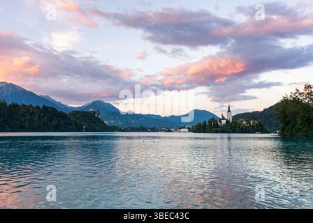 Mystic and magic sunset above the Bled lake, Slovenia. Beautiful magic purple colors and peaceful lake with church on the island. Magic sunset above t Stock Photo